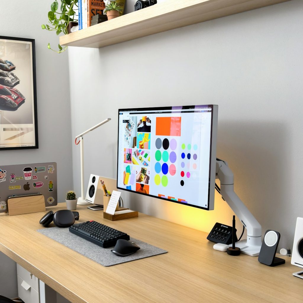 a computer monitor sitting on top of a wooden desk